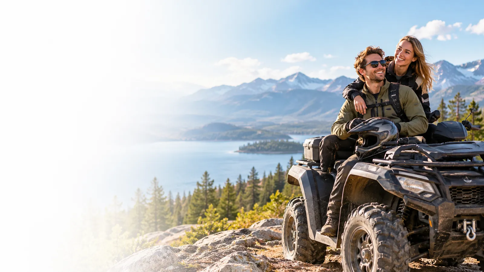 Couple with an ATV overlooking a mountain lake